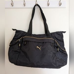Puma athletic bag/purse in black and gold